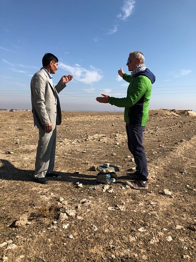 Project staff and the Mukhtar discussing the physical limitations of the land release area
