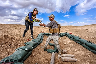 Clearance team members storing removed explosive ordnance