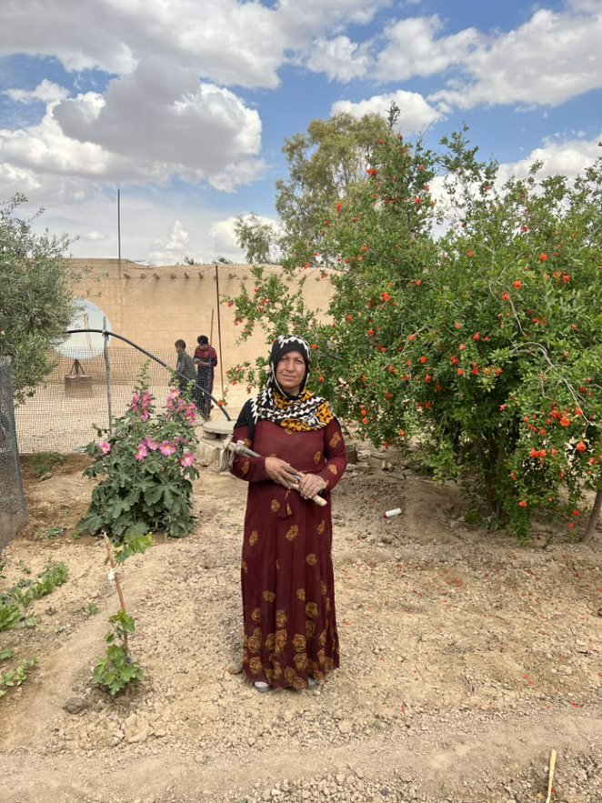 A project beneficiary in her garden.